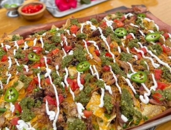 Smoked Pork Nachos on a sheet pan lined with Reynolds Kitchens Butcher Paper