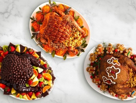 Three desserts made into the shape of cooked turkey platters.