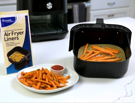 Air Fryer liner topped with sweet potato fries