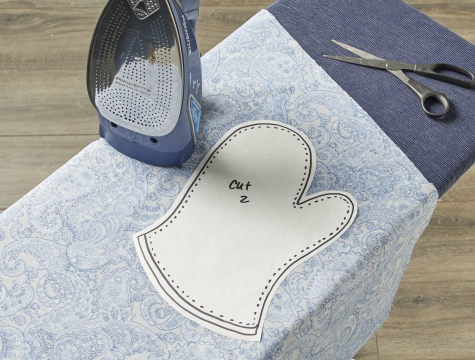 Freezer paper sitting on an ironing board being used to create a pattern stencil