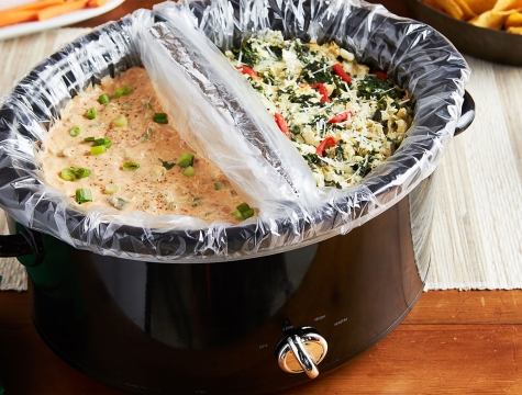 slow cooker lined with a slow cooker liner and filled with dip