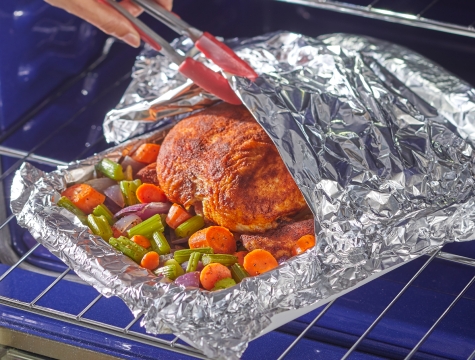 turkey on a foil lined baking sheet covered with a foil tent