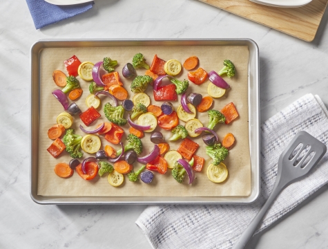 roasted vegetables on a baking sheet lined with unbleached parchment paper