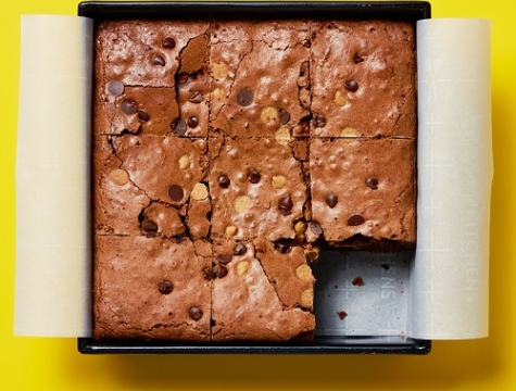 Fudge brownies in a parchment lined square cake pan
