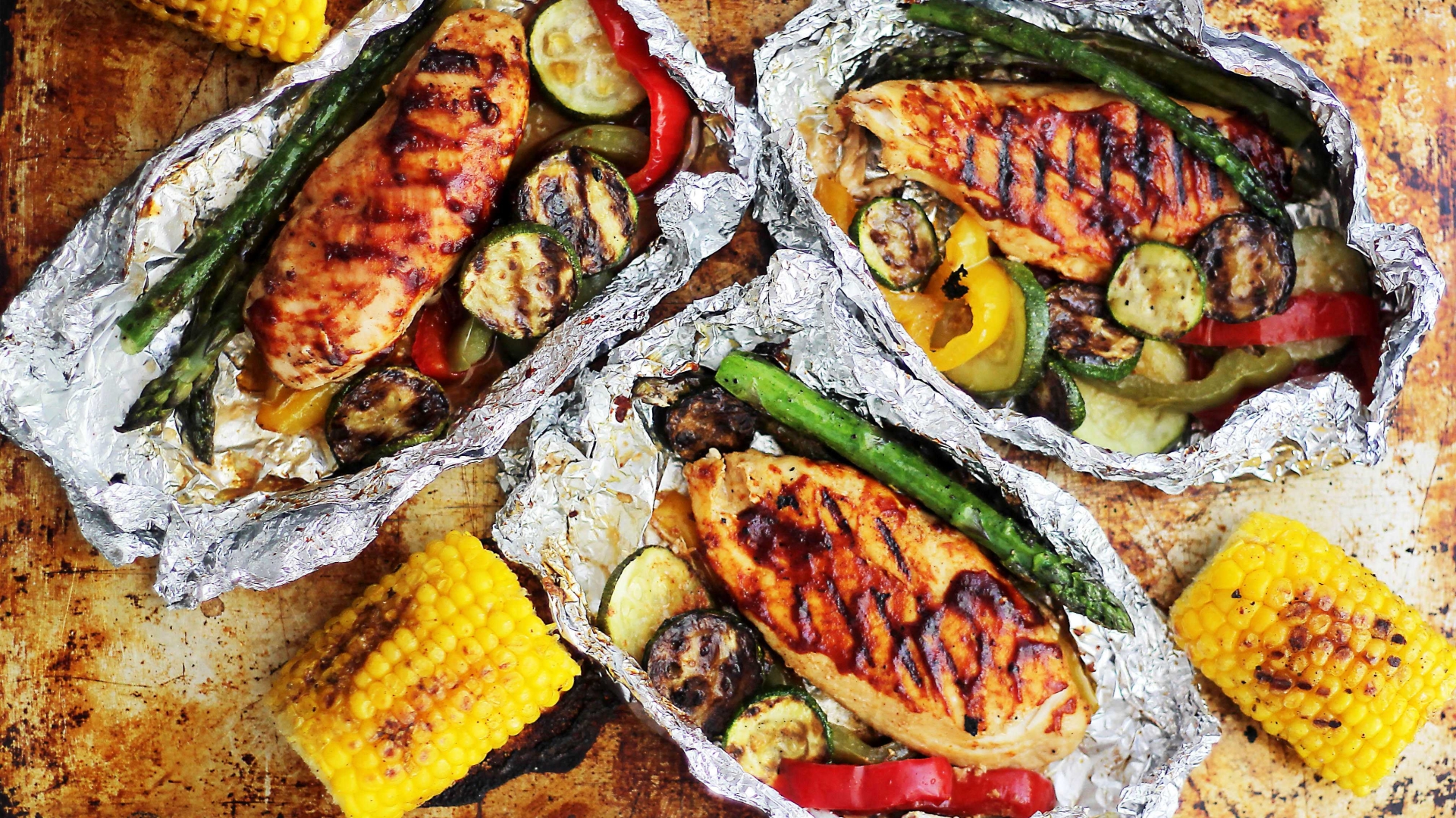 Grilled Chicken on a foil basket with corn and asparagus