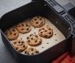 Baked cookies sitting on an air fryer liner in an air fryer