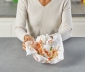 person lifting a sheet of countertop prep paper off the kitchen island