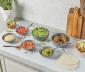 kitchen counter topped with countertop prep paper to serve a taco dinner buffet