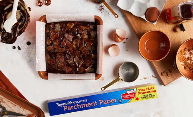 Bacon Bourbon Brownies in a square parchment lined pan