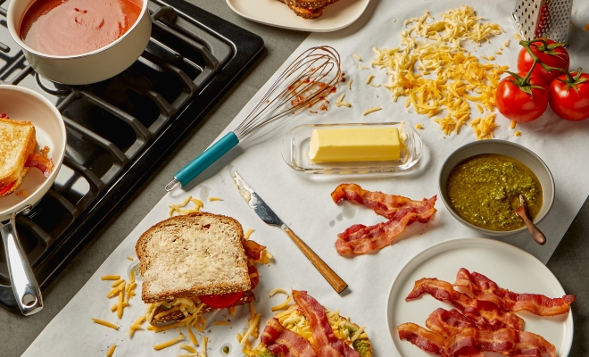 countertop prep paper lining a kitchen counter and topped with grilled cheese ingredients
