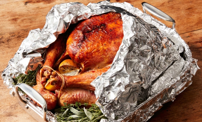 Turkey on a table wrapped in aluminium foil