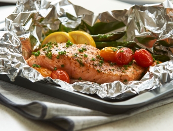 Salmon sitting on a piece of aluminum foil