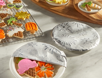 Summer themed sugar cookies on a plate covered with Reynolds Wrap Festive Fun Foil