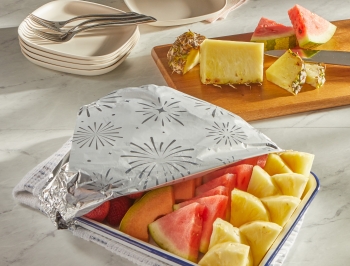 Tray of fruit partially wrapped in foil