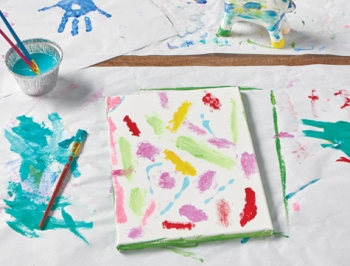 countertop prep paper sitting on a table with watercolor paintings on top