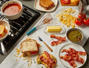 Grilled cheese prep station set up on a kitchen counter covered in Reynolds Kitchens Countertop Prep Paper