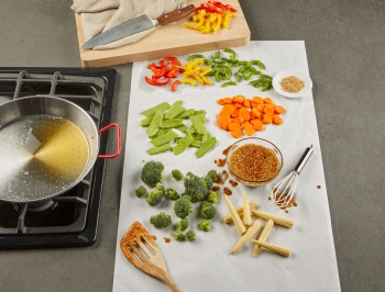 Stir fry prep station set up on a counter covered in Reynolds Kitchens Countertop Prep Paper