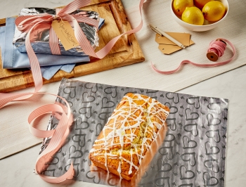 lemon poppyseed bread sitting on a sheet of Reynolds Wrap Fun Foil with embossed heart pattern