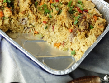casserole dish filled with cornbread dressing sitting on a table