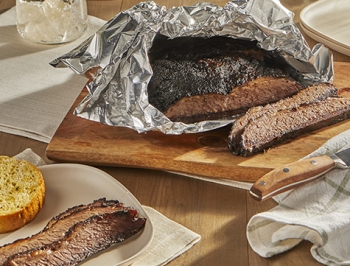 Brisket wrapped in a piece of aluminum foil